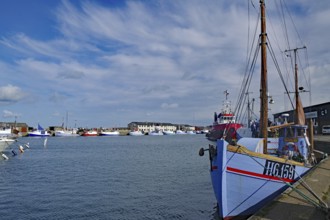 A harbour with fishing boats, blue sky and clouds in the background, Hirtshals, Jutland, Denmark,