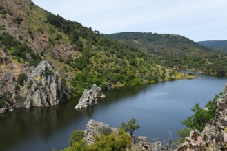 River landscape with steep mountain walls and green vegetation, at the Salto del Gitano, River