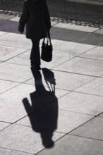 Passer-by with shadow, shopping bag, winter, Saxony, Germany, Europe