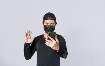 Man making video call isolated, guy making video call with face mask, face mask video call concept