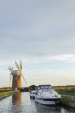 Windmill with boats moored on a river, Horsey, Norfolk, England, United Kingdom, Europe