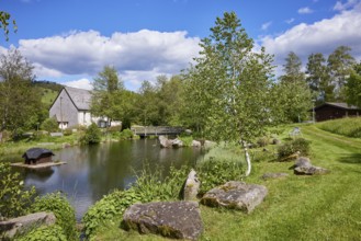 Pond with wooden bridge in the spa gardens of the Innerlehen district, Bernau im Black Forest,