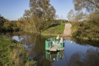 Cyclist, cycle tour, manually operated ferry across the Lippe near Halten am See, on the