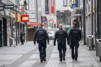 Effects of the coronavirus crisis, empty shopping street, patrol from the public order office,