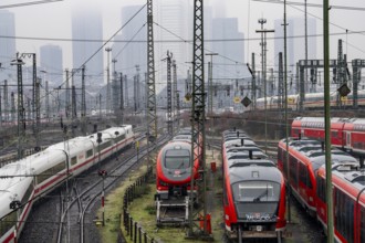 Railway tracks with regional and long-distance trains, ICE, after freezing rain, in front of