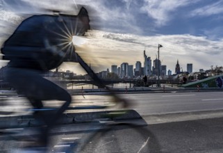 Skyline of Frankfurt am Main, skyscrapers, cyclists on the Flößerbrücke, Hesse, Germany, Europe