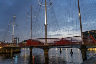 Cyclists on the Cirkelbroen cycle and pedestrian bridge, over the harbour, in the Christianshavens