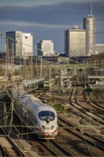 Train on the tracks west of Essen central station, skyline of the city centre, ICE train, North