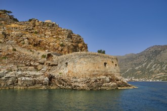 Round, stony old fortress on the seashore, embedded in a hilly landscape, Venetian sea fortress,