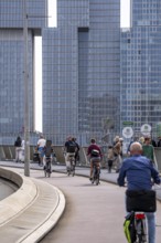 Cyclist on the cycle path of the Erasmus Bridge over the Nieuwe Maas, skyline of the skyscrapers on