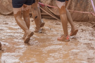 Shoes in the mud during a dynamic outdoor obstacle course