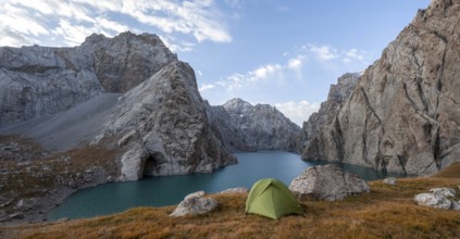 Wild camping, camping in the wilderness with a tent in front of mountain lake Kol Suu, Sary Beles