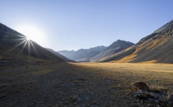 Mountain valley at sunrise, sun star, barren landscape, Burkhan valley, Tien Shan, Issyk Kul