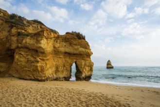 Rocky coast with beach and red rocks, Praia do Camilo, Lagos, Algarve, Portugal, Europe