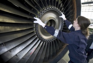 Trainees in the training workshop of Trainico, training as aircraft mechanics on a jet engine,