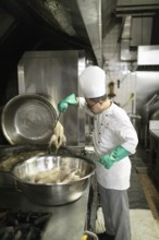 An assistant chef cooks salt ducks at the Mei Yuan restaurant in the Jinlin Hotel, Nanjing, China,