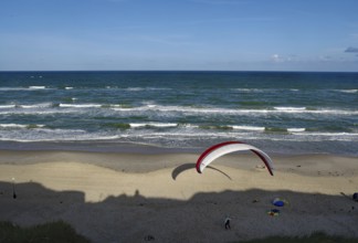 Paraglider soaring over a wide beach with blue sea, North Sea, Lokken, North Jutland, Jutland,