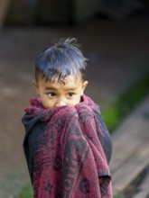 Boy with towel, Limbong village, Tana Toraja, Sulawesi, Indonesia, Asia