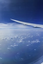 Blue sky, cloud structures over the Arabian Sea. View from the aircraft window during a flight from