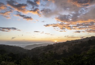 View to the sea over wooded hills, at sunset, cloud forest, Monte Verde, Puntarenas province, Costa