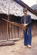 Elderly Laotian man playing a musical instrument, Northern Thailand, Asia 1971