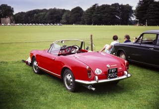 Red Alfa Romeo Spider 1600 at a polo match Cirencester, Gloucestershire, England, UK around 1967