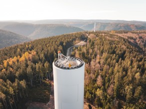 Breathtaking view from a wind turbine over an autumnal forest, wind turbine construction, Calmbach,