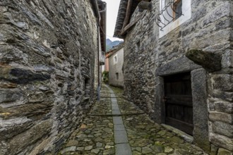 Typical Ticino stone houses in a narrow alley in the mountain village of Bordei, Centovalli, Canton