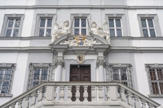 Entrance potal with sculptures and coat of arms of the baroque town hall, built in 1718, Iphofen,