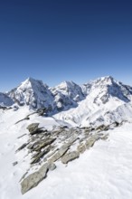 Mountain panorama with snow-covered mountain landscape in winter, view of mountain peaks