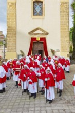 Confraternity of penitents gathering outside San Leonardo church, Enna, Siclly, Italy, Europe