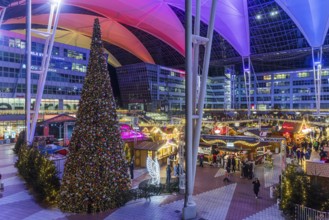 Christmas market at the airport in the evening, market stalls decorated for Christmas in front of