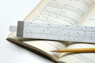 Slide rule on book, calculating aid