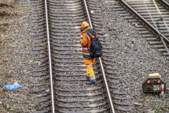 Worker on the railway tracks, after the end of his shift, walking home from the tracks, North