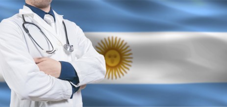 Argentina Health and Care concept. Professional doctor on Argentine flag. Doctor with crossed arms