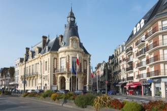 Historic building with French flags, surrounded by flowers and blue sky, Town Hall,