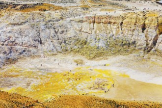 People walking around Stefanos crater moonlike landscape, Nisyros Island, Dodecanese Islands,