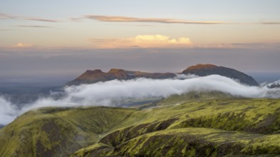 Fog between mountains, moss-covered volcanic mountain landscape, at sunset, Pakgil, Iceland, Europe