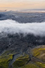 Fog, clouds moving around, glacier ice of the Kötlujökull glacier tongue at sunset, Myrdalsjökull