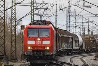 Goods train travelling on the winding Schuster Railway, overhead lines and infrastructure.