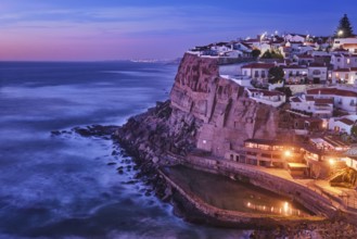 Scenic view of the seaside Azenhas do Mar fishing village on cliff on Atlantic ocean coast,