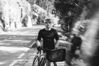 Road bike rider in spring in the Allgäu against the picturesque backdrop of the Alps, Bavaria,