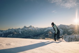 Summit bliss in the snow-covered winter landscape in the Tannheimer Tal in the Alps on the