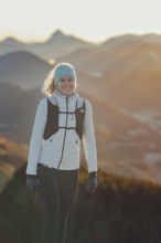 Trail running in autumn on the Jochberg on Lake Walchensee against the wonderful backdrop of the