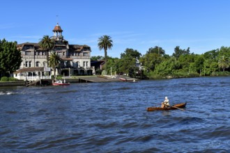 Rowers on the Rio Lujan in Tigre, the recreational area on the delta of the Rio Parana, with the