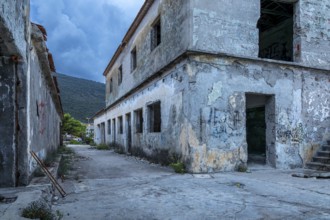 Abandoned, graffiti-covered building under a blue sky in an old town, Lost Place, Trpanj, Peljesac,