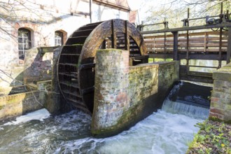 Water wheel with hydroelectric power plant of the Dölitz water mill, Leipzig, Saxony, Germany,