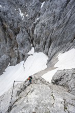 Mountaineer with helmet in a secured via ferrata, Zugspitze via ferrata, ascent to the Zugspitze,