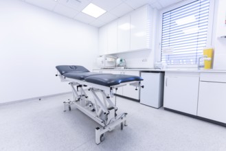 Modern clinic room with examination couch and window, bright and sterile, Urology, Germany, Europe