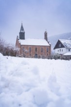 Snow-covered church in a snow-covered village, wintry calm and cold, Enzklösterle, district of